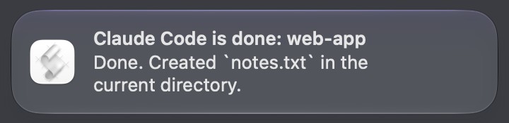A macOS notification banner titled Claude Code is done: web-app, reading Done. Created notes.txt in the current directory