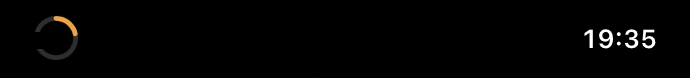 The closed MacBook notch with an orange progress ring on the left and 19:35 on the right
