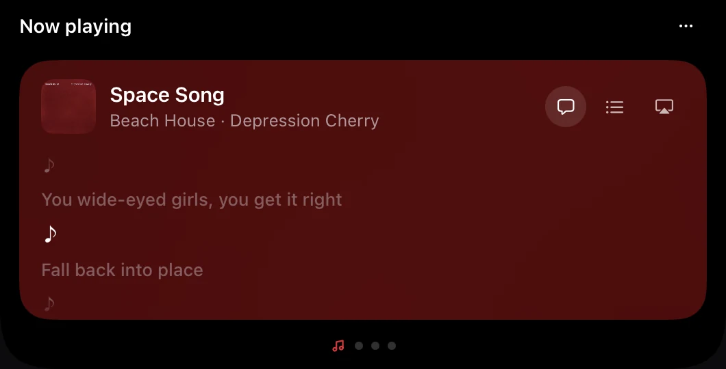 The same card showing synced lyrics: the song title at the top, two dimmed lyric lines and a lit music note for an instrumental moment